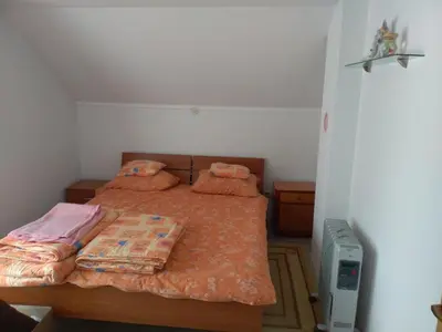 a bedroom with a bed with two pillows on it at Apartments Herc in Kupres