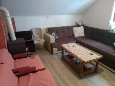 a living room with a couch and a table at Apartments Herc in Kupres