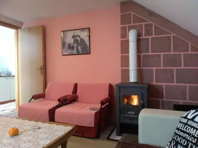 a living room with a couch and a fireplace at Apartments Herc in Kupres