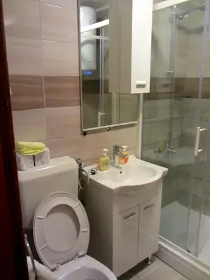 a bathroom with a toilet and a sink and a shower at Apartments Herc in Kupres
