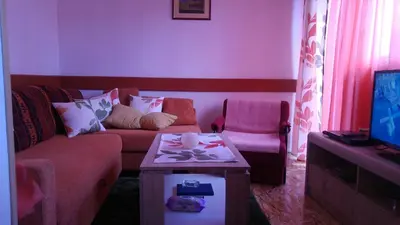 a living room with a couch and a table at Apartments Herc in Kupres