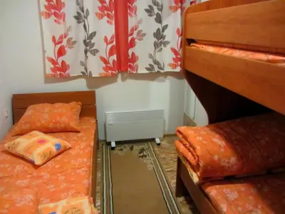 a bedroom with two bunk beds and a radiator at Apartments Herc in Kupres