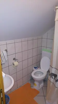 a bathroom with a toilet and a sink at Apartments Herc in Kupres