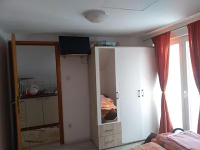 a bedroom with a closet and a mirror at Apartments Herc in Kupres