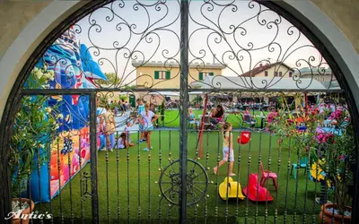 a gate with children playing at an amusement park at Motel pizzeria Antic's in Laktaši