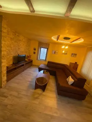a living room with a couch and a television at Motel pizzeria Antic's in Laktaši