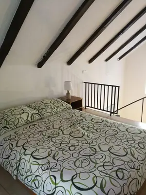 a bedroom with a bed with a patterned blanket at Holiday Home Nektar Park in Bihać