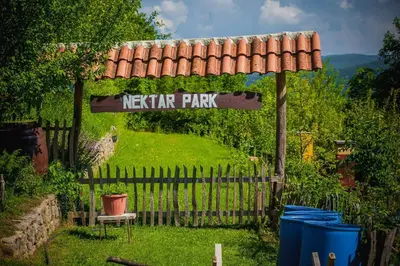 a sign that says keraria park in a garden at Holiday Home Nektar Park in Bihać