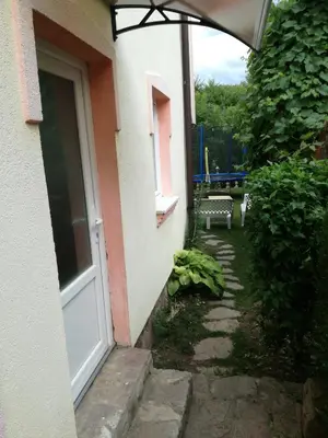 an entrance to a house with a door and a bench at Apartment Beganovic in Kulen Vakuf
