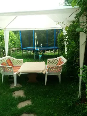 three chairs and a table and a swing in a yard at Apartment Beganovic in Kulen Vakuf