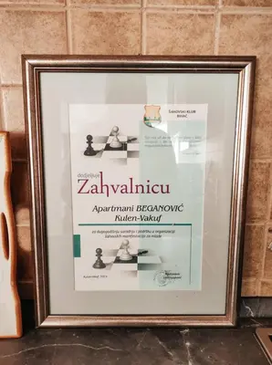 a framed picture of a poster of a zhakivciplinary approachciplinaryciplinary mirror at Apartment Beganovic in Kulen Vakuf
