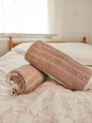 a brown towel sitting on top of a bed at Apartment Beganovic in Kulen Vakuf