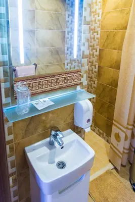 a bathroom with a sink and a mirror at Motel Orhideja in Donji Vakuf