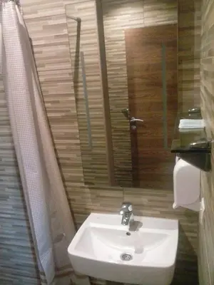 a bathroom with a sink and a mirror at Motel Orhideja in Donji Vakuf
