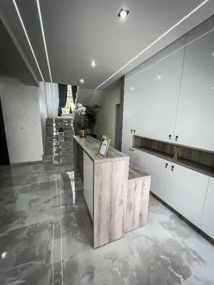 a kitchen with white cabinets and a counter at Apartmani Mila in Laktaši