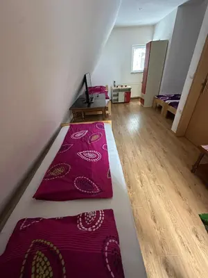a room with two red carpets on the floor at Vikendica Anja in Vlasic