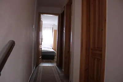 a hallway leading to a bedroom with a bed at Apartments Zoni in Vlasic