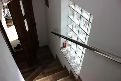 a stairway with a glass window on the wall at Apartments Zoni in Vlasic