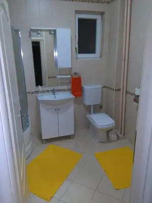 a bathroom with a sink and a toilet and a mirror at Apartment MA in Banja Luka