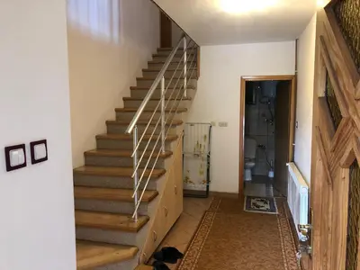 a staircase in a home with wooden railings at House Greda in Bihać