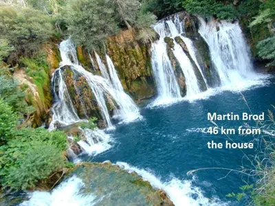 a waterfall in the middle of a river at House Greda in Bihać