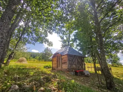 a wooden yurt in a field with trees at Etno Selo Dodig in Drvar