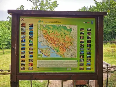 a sign in a park with a map at Etno Selo Dodig in Drvar