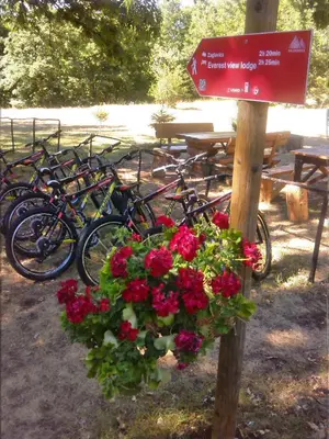 a bunch of bikes parked next to a sign with flowers at Etno Selo Dodig in Drvar