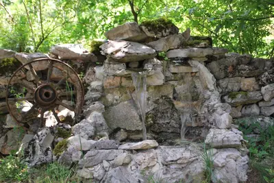 an old stone wall with a water fountain at Etno Selo Dodig in Drvar