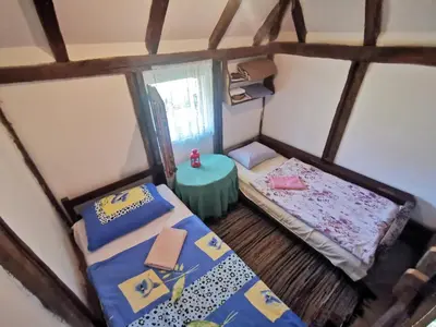 a small room with two beds and a table at Etno Selo Dodig in Drvar