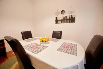 a white table with a bowl of fruit on it at Central Tuzla apt - free parking in Tuzla
