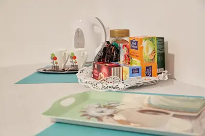 a table with a tray with books and a plate at Central Tuzla apt - free parking in Tuzla
