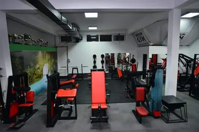 a gym with red and black chairs in a room at Motel Medium in Bihać