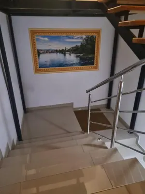 a staircase with a painting on the wall and a picture on the wall at Motel Medium in Bihać