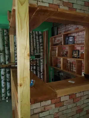 a mirror in a room with a shelf of books at Motel Medium in Bihać