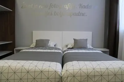 two beds sitting next to each other in a bedroom at Motel Korzo in Bihać