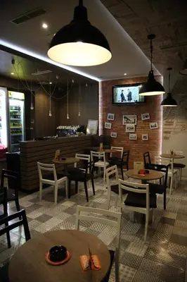 a restaurant with tables and chairs and a bar at Motel Korzo in Bihać