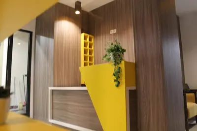 a yellow counter with a plant on it in a room at Motel Korzo in Bihać