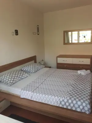 a bedroom with two twin beds and a mirror at Apartman Anita in Livno
