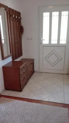 a room with a dresser and a window and a door at Apartman Anita in Livno