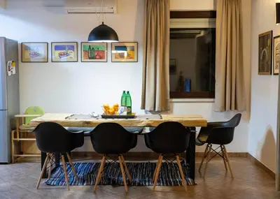 a dining room table with four chairs around it at Mila Holiday Home in Lohovo