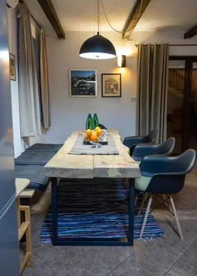 a dining room with a table and some chairs at Mila Holiday Home in Lohovo