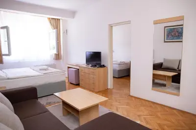 a living room with a couch and a mirror at Motel New Sanatron in Bosanski Novi