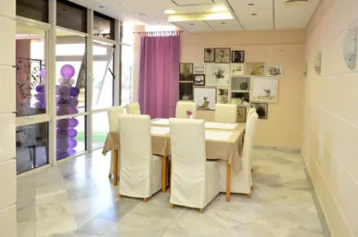 a dining room with a table and chairs at Motel New Sanatron in Bosanski Novi