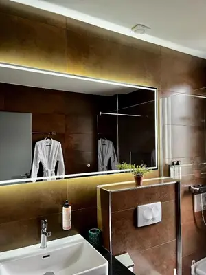 a bathroom with a sink and a mirror at Swiss Plus Hotel in Bihać