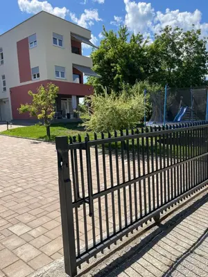a black fence in front of a building at Apartment Vila Tara in Bihać