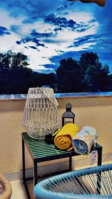 a table with a bird cage on a balcony at Apartment Vila Tara in Bihać