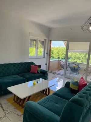 a living room with green couches and a table at Apartment Vila Tara in Bihać