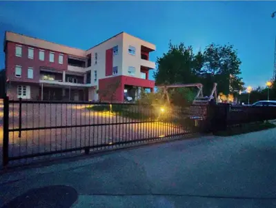 a building with a fence in front of a building at Apartment Vila Tara in Bihać