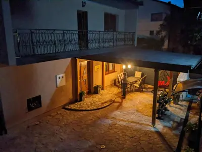 a view of a house with a balcony and a table at House Leyla in Bihać